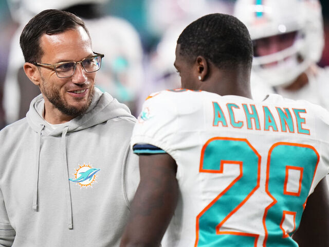 MIAMI GARDENS, FLORIDA - JANUARY 07: Miami Dolphins head coach Mike McDaniel and De'Von Achane #28 of the Miami Dolphins warm up prior to a game against the Buffalo Bills at Hard Rock Stadium on January 07, 2024 in Miami Gardens, Florida.