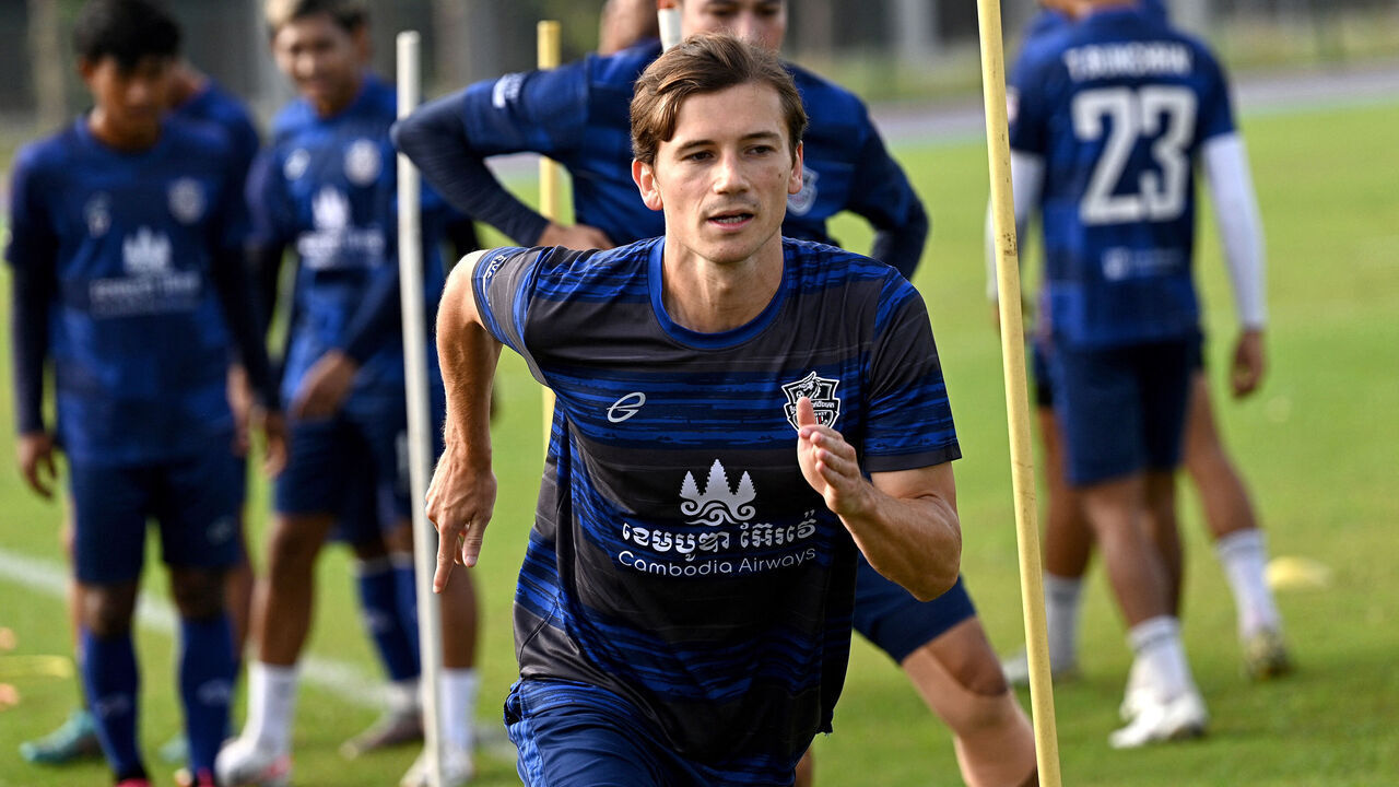 This photo taken on January 3, 2024 shows French footballer Antoine Lemarie (C) warming up during a training session with the Cambodian premier league's Boeung Ket FC team at the Morodok Techo National Stadium in Phnom Penh. Dribbling a football, Antoine Lemarie might be thousands of miles from home, but the journeyman player is now on top of the world having secured his first professional contract and scored online fame - in Cambodia.