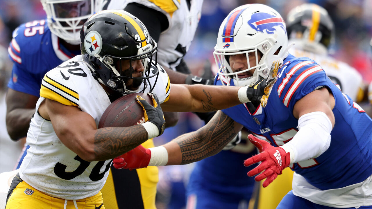 ORCHARD PARK, NEW YORK - OCTOBER 09: Jaylen Warren #30 of the Pittsburgh Steelers is tackled by AJ Epenesa #57 of the Buffalo Bills during the fourth quarter at Highmark Stadium on October 09, 2022 in Orchard Park, New York.