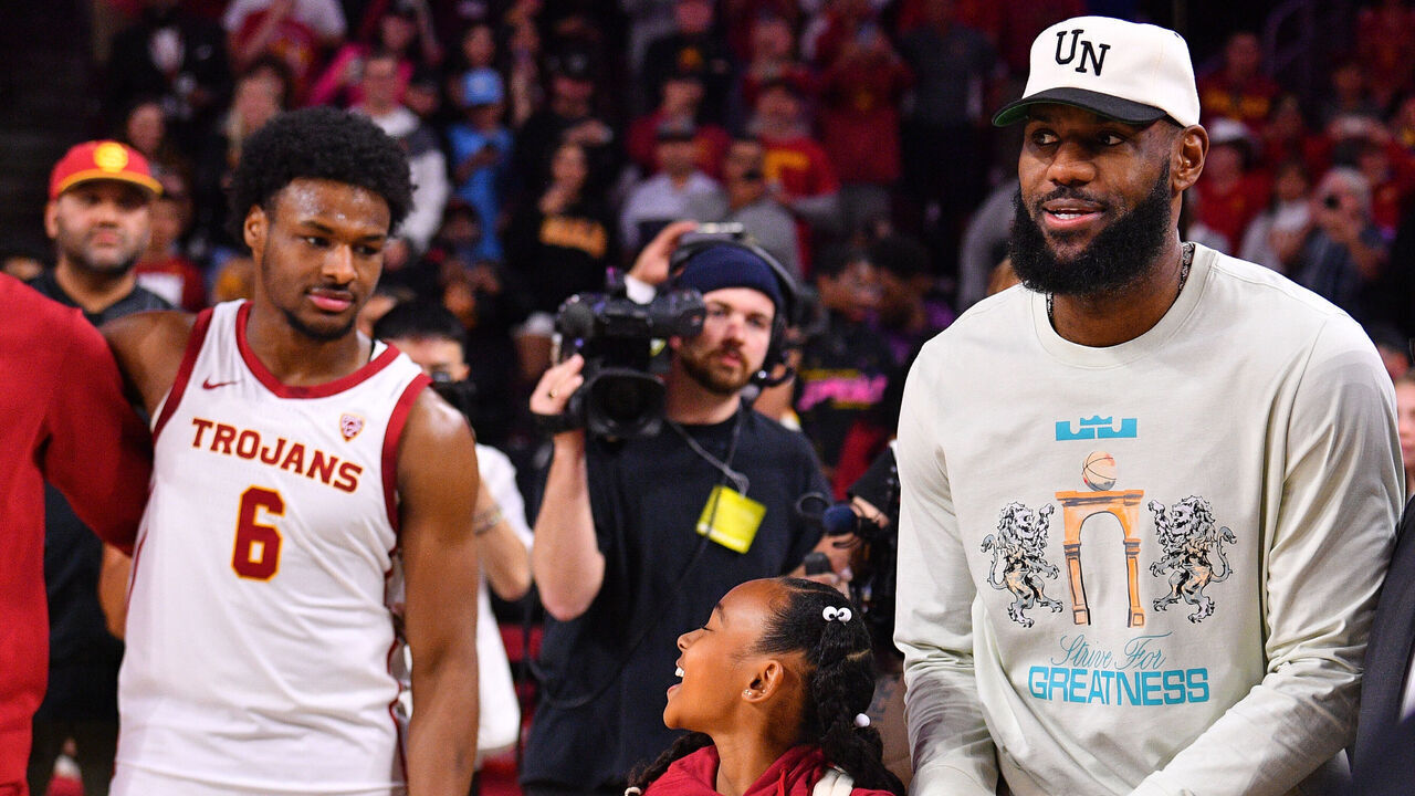 LOS ANGELES, CA - DECEMBER 10: Los Angeles Lakers forward Lebron James and his daughter Zhuri Nova walk past USC Trojans guard Bronny James (6) before the college basketball game between the Long Beach State 49ers and the USC Trojans on December 10, 2023 at Galen Center in Los Angeles, CA.