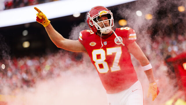 KANSAS CITY, MISSOURI - DECEMBER 31: Travis Kelce #87 of the Kansas City Chiefs runs onto the field during player introductions before an NFL football game against the Cincinnati Bengals at GEHA Field at Arrowhead Stadium on December 31, 2023 in Kansas City, Missouri.