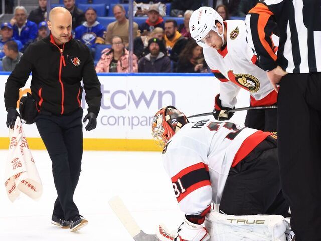 BUFFALO, NEW YORK - JANUARY 11: Anton Forsberg #31 of the Ottawa Senators is tended to after being injured during an NHL game against the Buffalo Sabres on January 11, 2024 at KeyBank Center in Buffalo, New York.
