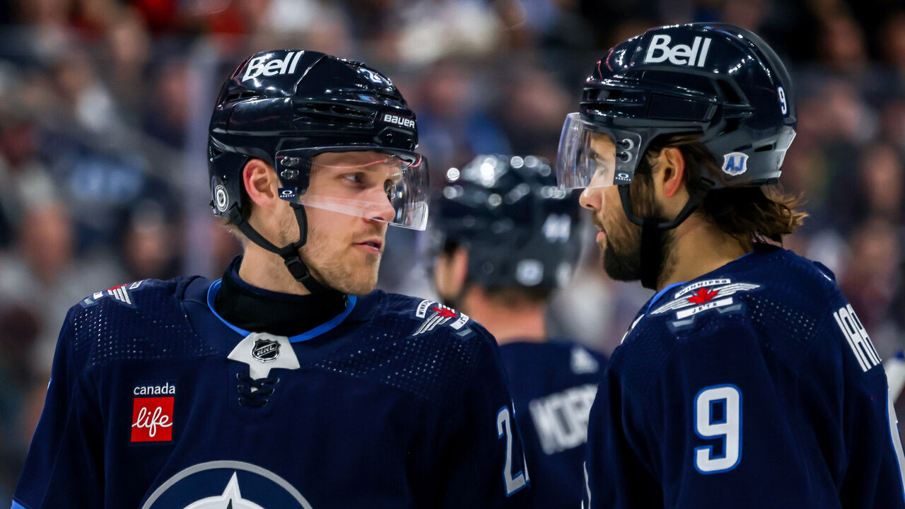 WINNIPEG, CANADA - JANUARY 11: Nikolaj Ehlers #27 and Alex Iafallo #9 of the Winnipeg Jets discuss strategy during a second period stoppage in play against the Chicago Blackhawks at the Canada Life Centre on January 11, 2024 in Winnipeg, Manitoba, Canada.