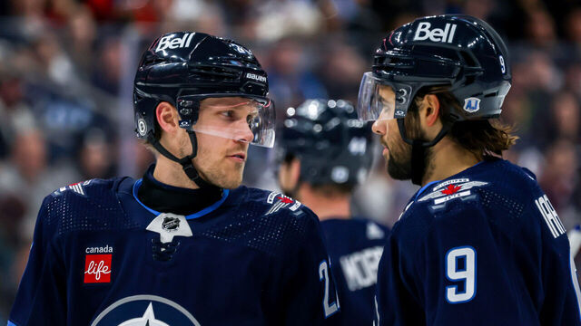 WINNIPEG, CANADA - JANUARY 11: Nikolaj Ehlers #27 and Alex Iafallo #9 of the Winnipeg Jets discuss strategy during a second period stoppage in play against the Chicago Blackhawks at the Canada Life Centre on January 11, 2024 in Winnipeg, Manitoba, Canada.