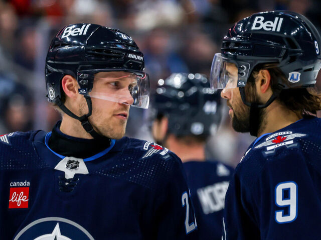 WINNIPEG, CANADA - JANUARY 11: Nikolaj Ehlers #27 and Alex Iafallo #9 of the Winnipeg Jets discuss strategy during a second period stoppage in play against the Chicago Blackhawks at the Canada Life Centre on January 11, 2024 in Winnipeg, Manitoba, Canada.