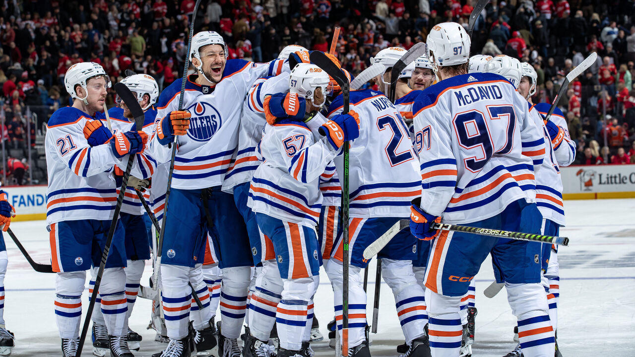 DETROIT, MI - JANUARY 11: Darnell Nurse (25) of the Edmonton Oilers celebrates his game winning overtime goal with teammates against the Detroit Red Wings at Little Caesars Arena on January 11, 2024 in Detroit, Michigan. Edmonton defeated Detroit in O.T. 3-2.
