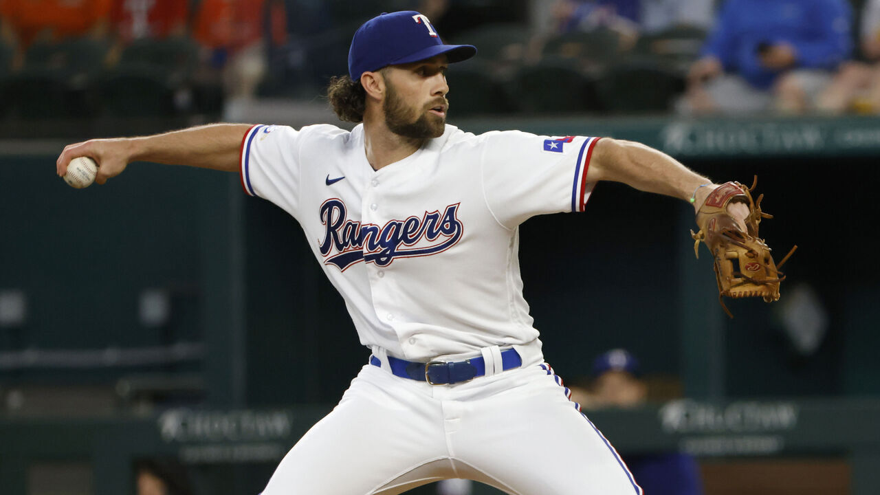 ARLINGTON, TX - JUNE 15: Charlie Culberson #11 of the Texas Rangers pitches against the Houston Astros during the ninth inning at Globe Life Field on June 15, 2022 in Arlington, Texas. The Astros won 9-2.