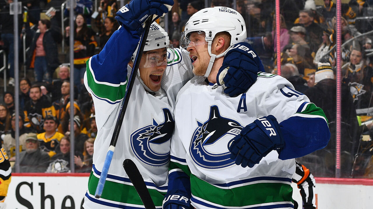 PITTSBURGH, PENNSYLVANIA - JANUARY 11: Elias Pettersson #40 of the Vancouver Canucks celebrates his overtime goal with Andrei Kuzmenko #96 against the Pittsburgh Penguins at PPG PAINTS Arena on January 11, 2024 in Pittsburgh, Pennsylvania.