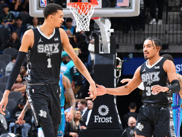 SAN ANTONIO, TX - JANUARY 12: Victor Wembanyama #1 high fives Tre Jones #33 of the San Antonio Spurs during the game against the Charlotte Hornets on January 12, 2024 at the Frost Bank Center in San Antonio, Texas. Mandatory Copyright Notice: Copyright 2024 NBAE (Photos by Michael Gonzales/NBAE via Getty Images)