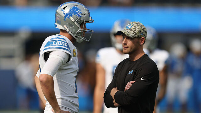 INGLEWOOD, CALIFORNIA - NOVEMBER 12: Jared Goff #16 of the Detroit Lions talks with offensive coordinator Ben Johnson before the game against the Los Angeles Chargers at SoFi Stadium on November 12, 2023 in Inglewood, California.