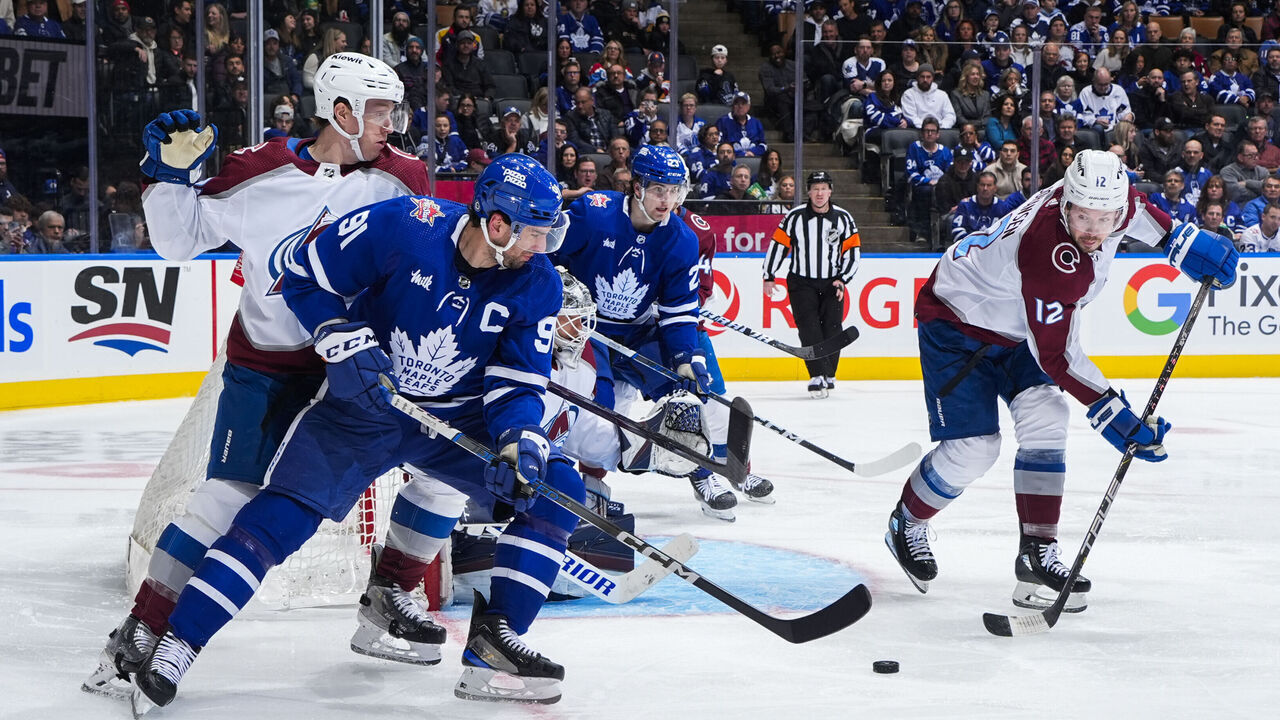 TORONTO, ON - JANUARY 13: John Tavares #91 of the Toronto Maple Leafs battles for the puck against Ryan Johansen #12 of the Colorado Avalanche during the third period at Scotiabank Arena on January 13, 2024 in Toronto, Ontario, Canada.