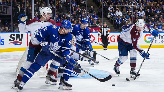 TORONTO, ON - JANUARY 13: John Tavares #91 of the Toronto Maple Leafs battles for the puck against Ryan Johansen #12 of the Colorado Avalanche during the third period at Scotiabank Arena on January 13, 2024 in Toronto, Ontario, Canada.