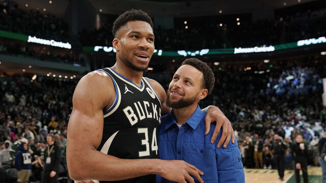 MILWAUKEE, WISCONSIN - JANUARY 13: Giannis Antetokounmpo #34 of the Milwaukee Bucks and Stephen Curry #30 of the Golden State Warriors talk after a game at Fiserv Forum on January 13, 2024 in Milwaukee, Wisconsin.