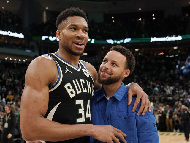 MILWAUKEE, WISCONSIN - JANUARY 13: Giannis Antetokounmpo #34 of the Milwaukee Bucks and Stephen Curry #30 of the Golden State Warriors talk after a game at Fiserv Forum on January 13, 2024 in Milwaukee, Wisconsin.