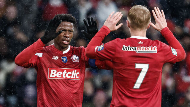 Lille's Canadian forward #09 Jonathan David celebrates with his teammate Lille's Icelandic midfielder #07 Hakon Haraldsson (R) after scoring his team's tenth goal during the French Cup football match between Lille LOSC and Golden Lion FC at the Pierre-Mauroy Stadium in Villeneuve-d'Ascq, northern France, on January 6, 2024.