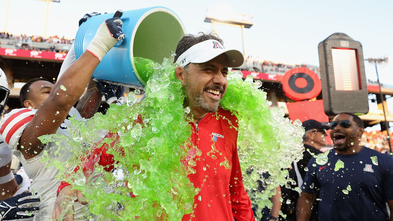 TEMPE, ARIZONA - NOVEMBER 25: Head coach Jedd Fisch of the Arizona Wildcats is dunked with powerade during the final moments of the NCAAF game against the Arizona State Sun Devils at Mountain America Stadium on November 25, 2023 in Tempe, Arizona. The Wildcats defeated the Sun Devils 59-23.