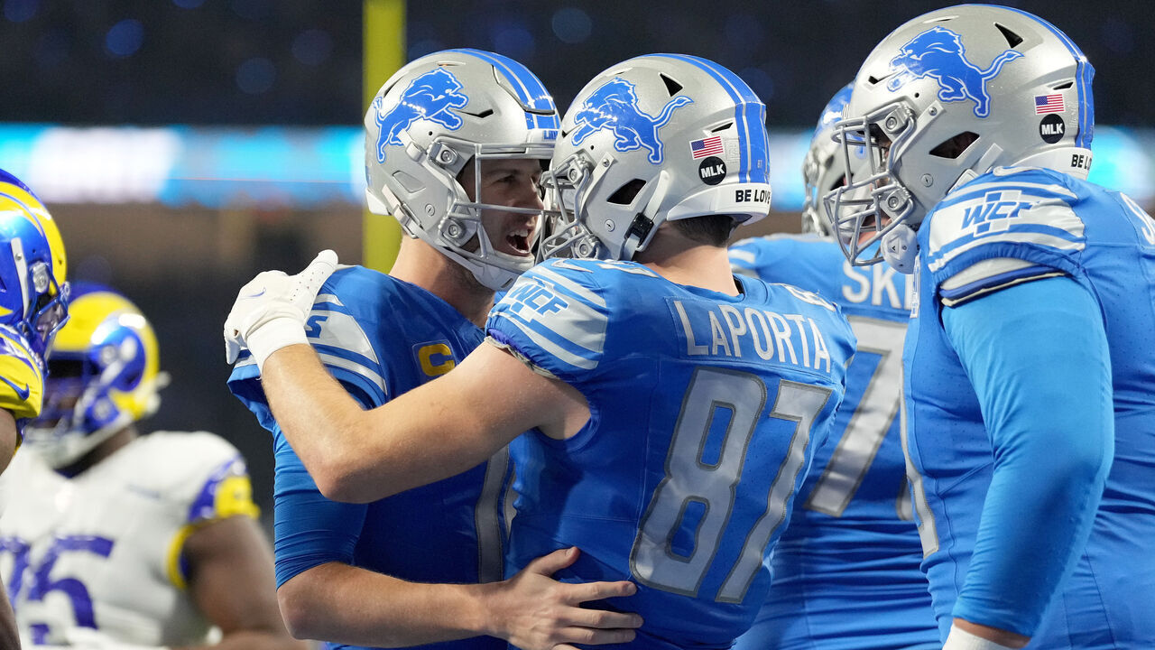 DETROIT, MICHIGAN - JANUARY 14: Sam LaPorta #87 of the Detroit Lions celebrates his touchdown with Jared Goff #16 during the second quarter against the Los Angeles Rams in the NFC Wild Card Playoffs at Ford Field on January 14, 2024 in Detroit, Michigan.