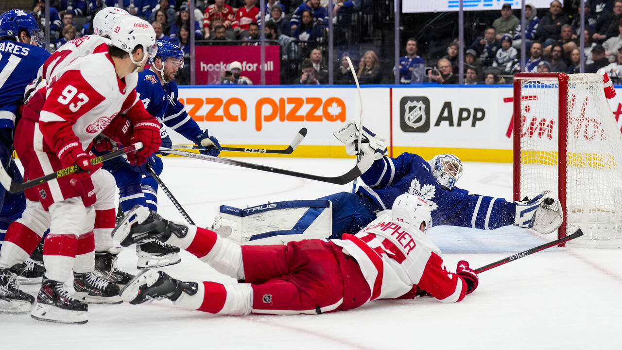TORONTO, ON - JANUARY 14: Ilya Samsonov #35 of the Toronto Maple Leafs makes a glove save against J.T. Compher #37 of the Detroit Red Wings during the third period at Scotiabank Arena on January 14, 2024 in Toronto, Ontario, Canada.