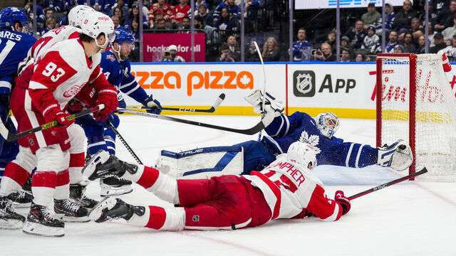 TORONTO, ON - JANUARY 14: Ilya Samsonov #35 of the Toronto Maple Leafs makes a glove save against J.T. Compher #37 of the Detroit Red Wings during the third period at Scotiabank Arena on January 14, 2024 in Toronto, Ontario, Canada.