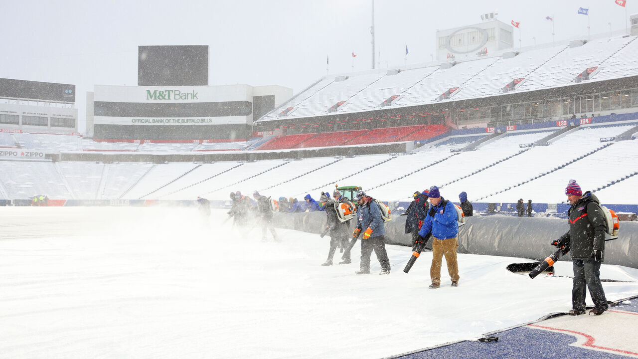 ORCHARD PARK, NY - DECEMBER 17: Ground crews clear snow from the field before a game between the Buffalo Bills and the Miami Dolphins at Highmark Stadium on December 17, 2022 in Orchard Park, New York.