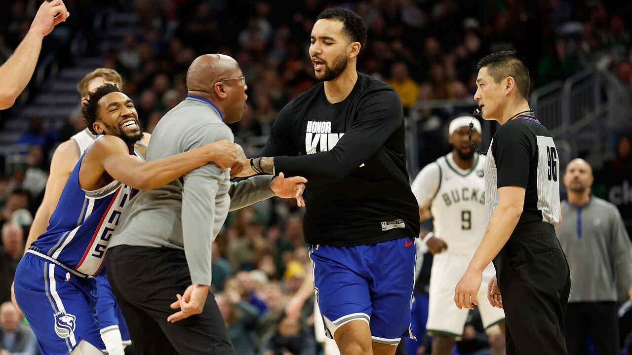 MILWAUKEE, WISCONSIN - JANUARY 14: Mike Brown head coach of the Sacramento Kings is held back by players after charging at referee Intae Hwang #96 during the second half of the game against the Milwaukee Bucks at Fiserv Forum on January 14, 2024 in Milwaukee, Wisconsin.