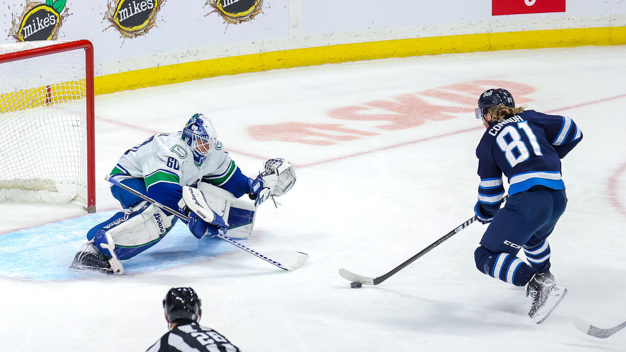 WINNIPEG, CANADA - DECEMBER 29: Kyle Connor #81 of the Winnipeg Jets moves in for the shot on goaltender Collin Delia #60 of the Vancouver Canucks during third period action at Canada Life Centre on December 29, 2022 in Winnipeg, Manitoba, Canada.