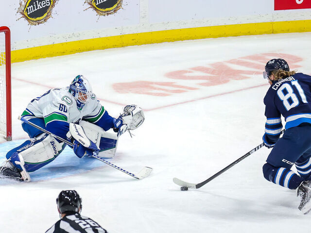 WINNIPEG, CANADA - DECEMBER 29: Kyle Connor #81 of the Winnipeg Jets moves in for the shot on goaltender Collin Delia #60 of the Vancouver Canucks during third period action at Canada Life Centre on December 29, 2022 in Winnipeg, Manitoba, Canada.