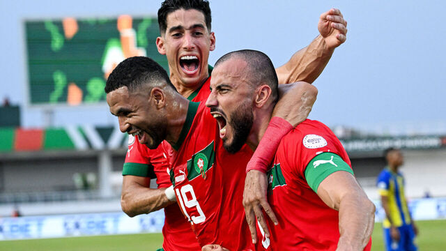 TOPSHOT - Morocco's defender #6 Romain Saiss (R) celebrates with Morocco's forward #19 Youssef En-Nesyri (C) and Morocco's defender #5 Nayef Aguerd (L) after scoring his team's first goal during the Africa Cup of Nations (CAN) 2024 group F football match between Morocco and Tanzania at Stade Laurent Pokou in San Pedro on January 17, 2024.
