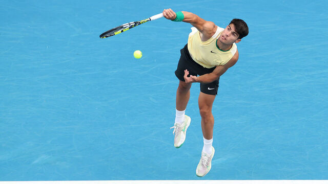 MELBOURNE, AUSTRALIA - JANUARY 18: Carlos Alcaraz of Spain serves in their round two singles match against Lorenzo Sonego of Italy during the 2024 Australian Open at Melbourne Park on January 18, 2024 in Melbourne, Australia.