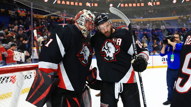 BUFFALO, NEW YORK - JANUARY 18: Ukko-Pekka Luukkonen #1 of the Buffalo Sabres is congratulated by Zemgus Girgensons #28 following his second consecutive shutout, a 3-0 victory against the Chicago Blackhawks, in an NHL game on January 18, 2024 at KeyBank Center in Buffalo, New York.
