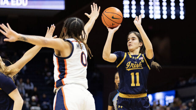CHARLOTTESVILLE, VIRGINIA - JANUARY 18: Sonia Citron #11 of the Notre Dame Fighting Irish shoots over Olivia McGhee #0 of the Virginia Cavaliers in the first half during a game at John Paul Jones Arena on January 18, 2024 in Charlottesville, Virginia.