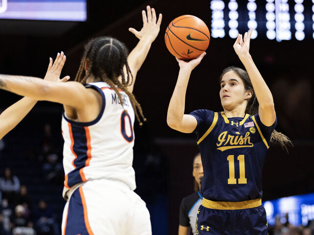 CHARLOTTESVILLE, VIRGINIA - JANUARY 18: Sonia Citron #11 of the Notre Dame Fighting Irish shoots over Olivia McGhee #0 of the Virginia Cavaliers in the first half during a game at John Paul Jones Arena on January 18, 2024 in Charlottesville, Virginia.