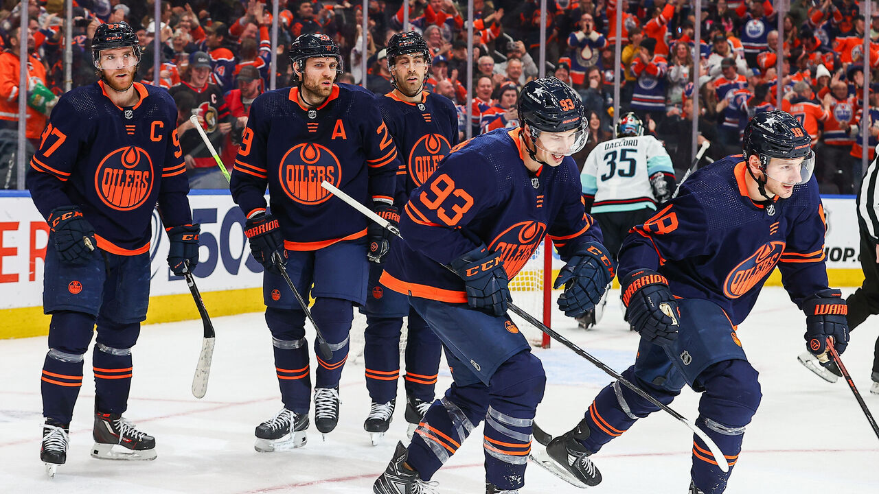EDMONTON, AB - JANUARY 18: Edmonton Oilers Center Connor McDavid (97) and Edmonton Oilers Right Wing Zach Hyman (18) celebrate a power play goal in the third period of the Edmonton Oilers game versus the Seattle Kraken on January 18, 2024 at Rogers Place in Edmonton, AB.
