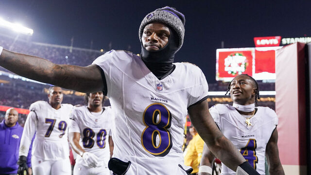 SANTA CLARA, CALIFORNIA - DECEMBER 25: Lamar Jackson #8 of the Baltimore Ravens high fives a fan while heading into the locker room after the first half against the San Francisco 49ers at Levi's Stadium on December 25, 2023 in Santa Clara, California.