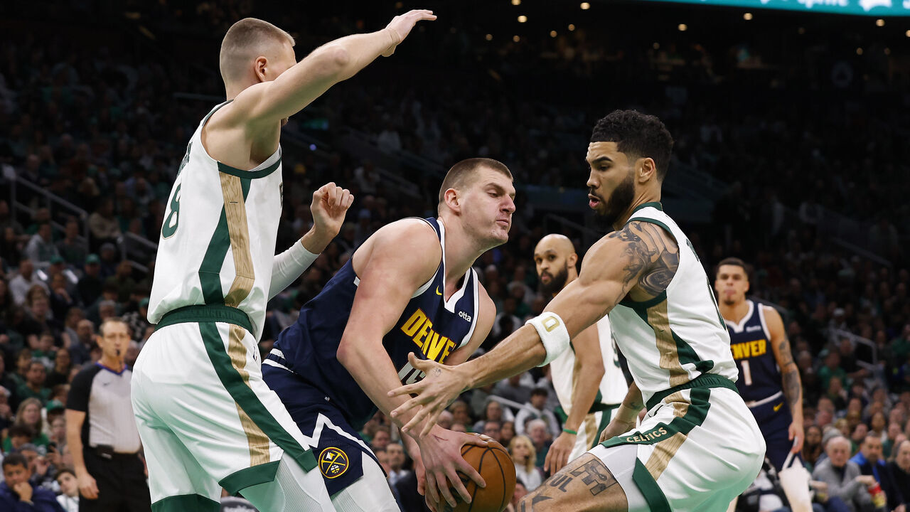 BOSTON, MA - JANUARY 19: Nikola Jokic #15 of the Denver Nuggets tries to get away from Jayson Tatum #0 of the Boston Celtics during the first quarter at TD Garden on January 19, 2024 in Boston, Massachusetts. NOTE TO USER: User expressly acknowledges and agrees that, by downloading and/or using this Photograph, user is consenting to the terms and conditions of the Getty Images License Agreement.
