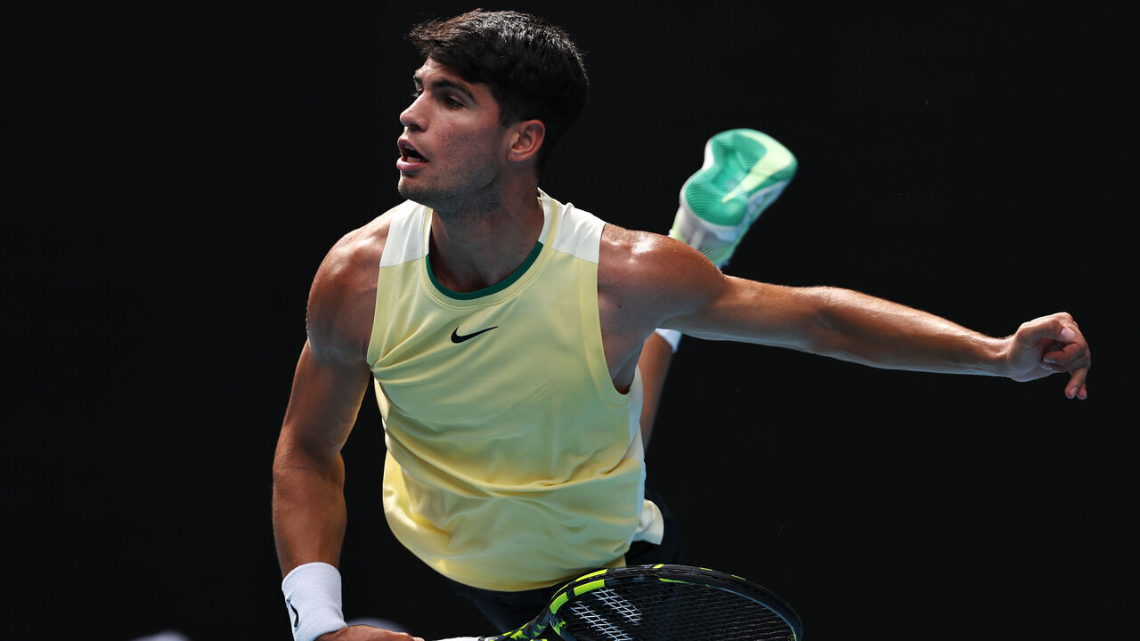 MELBOURNE, AUSTRALIA - JANUARY 20: Carlos Alcaraz of Spain serves in their round three singles match against Juncheng Shang of China during the 2024 Australian Open at Melbourne Park on January 20, 2024 in Melbourne, Australia.