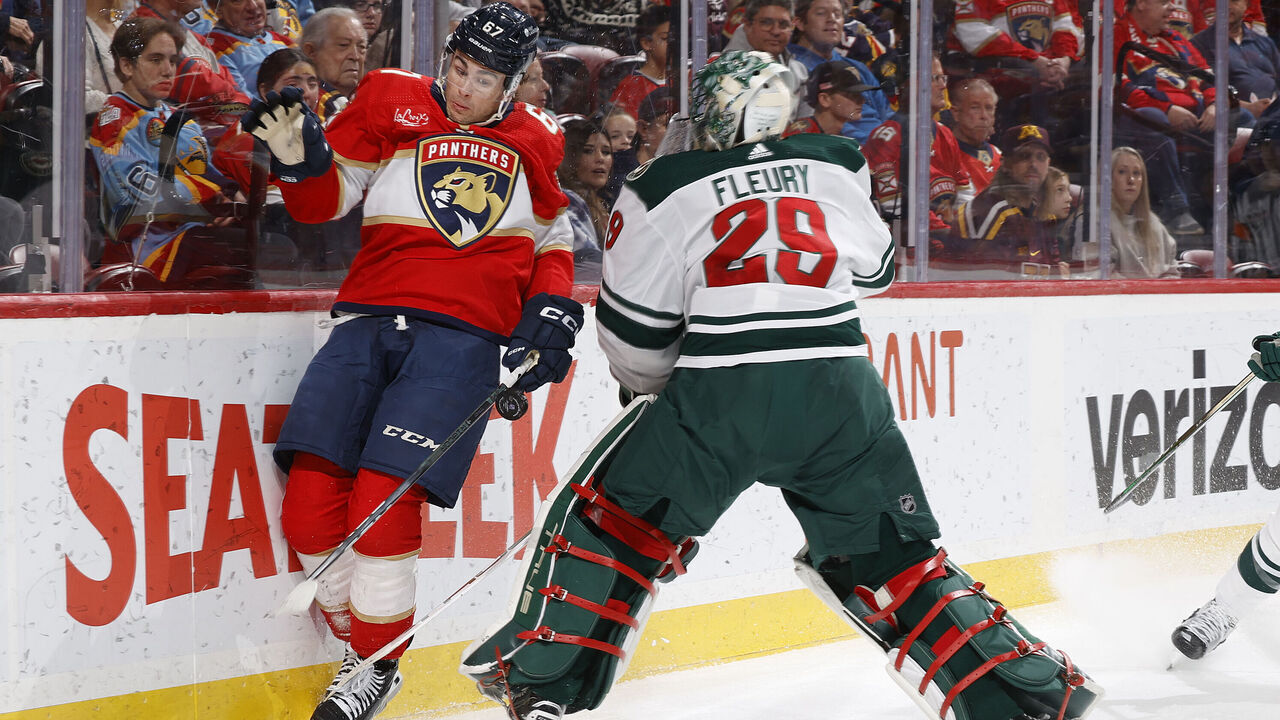 SUNRISE, FL - JANUARY 19: William Lockwood #67 of the Florida Panthers runs into Goaltender Marc-Andre Fleury #29 of the Minnesota Wild behind the net during first period action at the Amerant Bank Arena on January 19, 2024 in Sunrise, Florida.