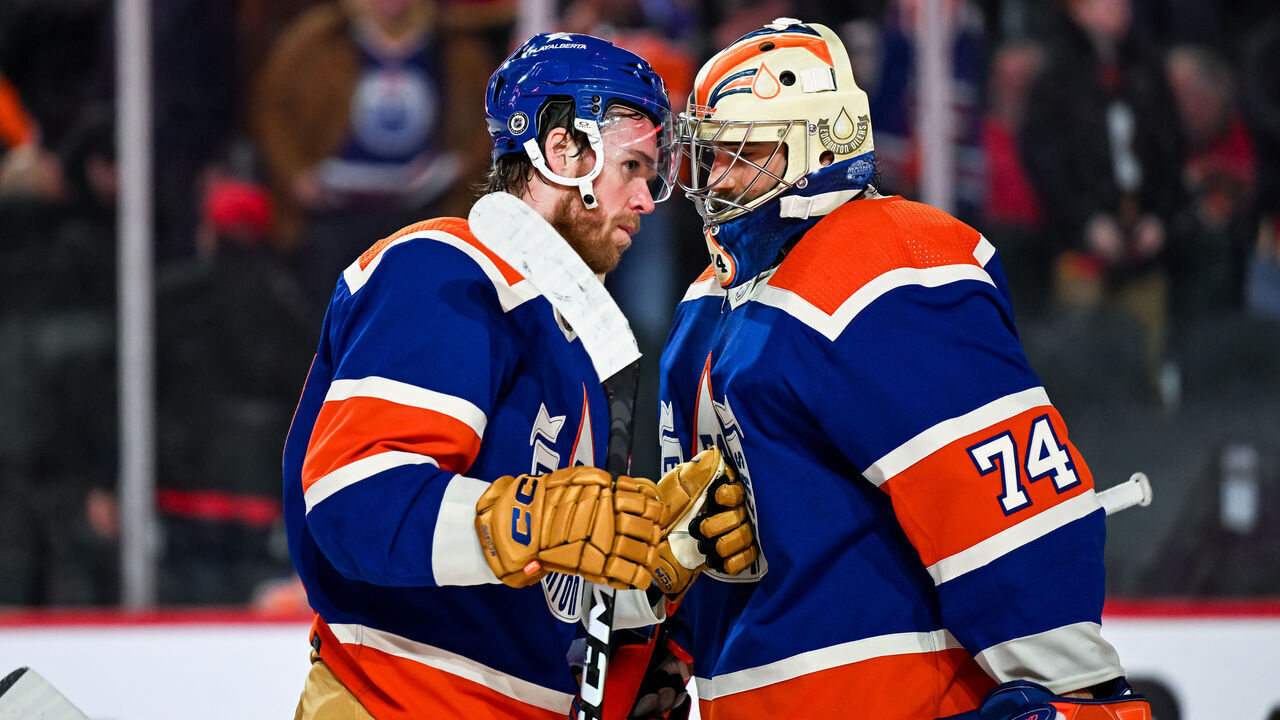 CALGARY, AB - JANUARY 20: Edmonton Oilers Center Connor McDavid (97) and Edmonton Oilers Goalie Stuart Skinner (74) celebrate their 3-1 win over the Calgary Flames during an NHL game on January 20, 2024, at the Scotiabank Saddledome in Calgary, AB.
