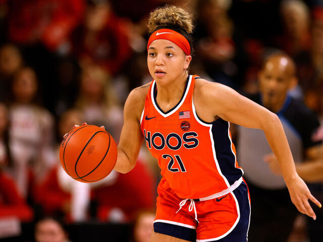RALEIGH, NORTH CAROLINA - JANUARY 11: Kymora Johnson #21 of the Virginia Cavaliers dribbles up court against the NC State Wolfpack at Reynolds Coliseum on January 11, 2024 in Raleigh, North Carolina. NC State won 93-66.