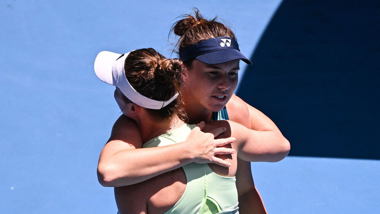 Ukraine's Elina Svitolina (front) hugs Czech Republic's Linda Noskova after retiring injured during their women's singles match on day nine of the Australian Open tennis tournament in Melbourne on January 22, 2024.