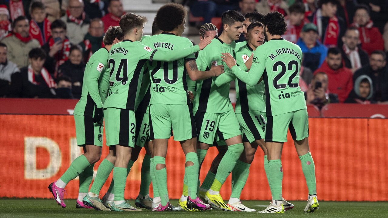 Atletico Madrid's Spanish forward #19 Alvaro Morata (C) celebrates with teammates after scoring his team's first goal during the Spanish league football match between Granada FC and Club Atletico de Madrid at the Nuevo Estadio de Los Carmenes in Granada on January 22, 2024.