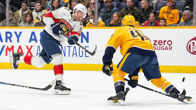 NASHVILLE, TENNESSEE - JANUARY 22: Carter Verhaeghe #23 of the Florida Panthers shoots the puck against Alexandre Carrier #45 of the Nashville Predators during an NHL game at Bridgestone Arena on January 22, 2024 in Nashville, Tennessee.