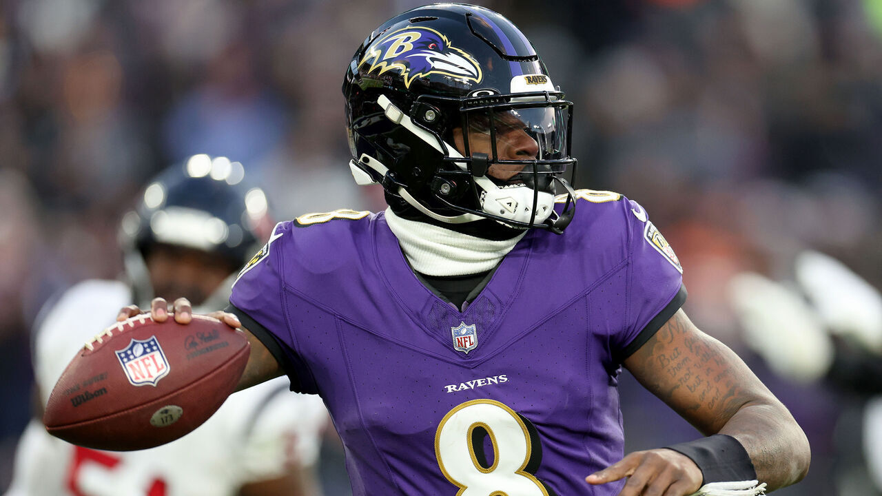 BALTIMORE, MARYLAND - JANUARY 20: Lamar Jackson #8 of the Baltimore Ravens looks to throw a pass against the Houston Texans during the first quarter in the AFC Divisional Playoff game at M&T Bank Stadium on January 20, 2024 in Baltimore, Maryland.