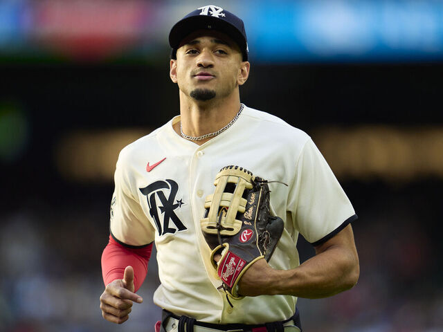 ARLINGTON, TX - APRIL 21: Bubba Thompson #8 of the Texas Rangers runs to the dugout during the game between the Oakland Athletics and the Texas Rangers at Globe Life Field on Friday, April 21, 2023 in Arlington, Texas.