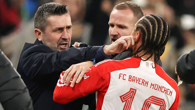 MUNICH, GERMANY - JANUARY 24: Dispute between Leroy Sane of Bayern Muenchen and Nenad Bjelica Coach of FC Union Berlin during the Bundesliga match between FC Bayern München and 1. FC Union Berlin at Allianz Arena on January 24, 2024 in Munich, Germany.