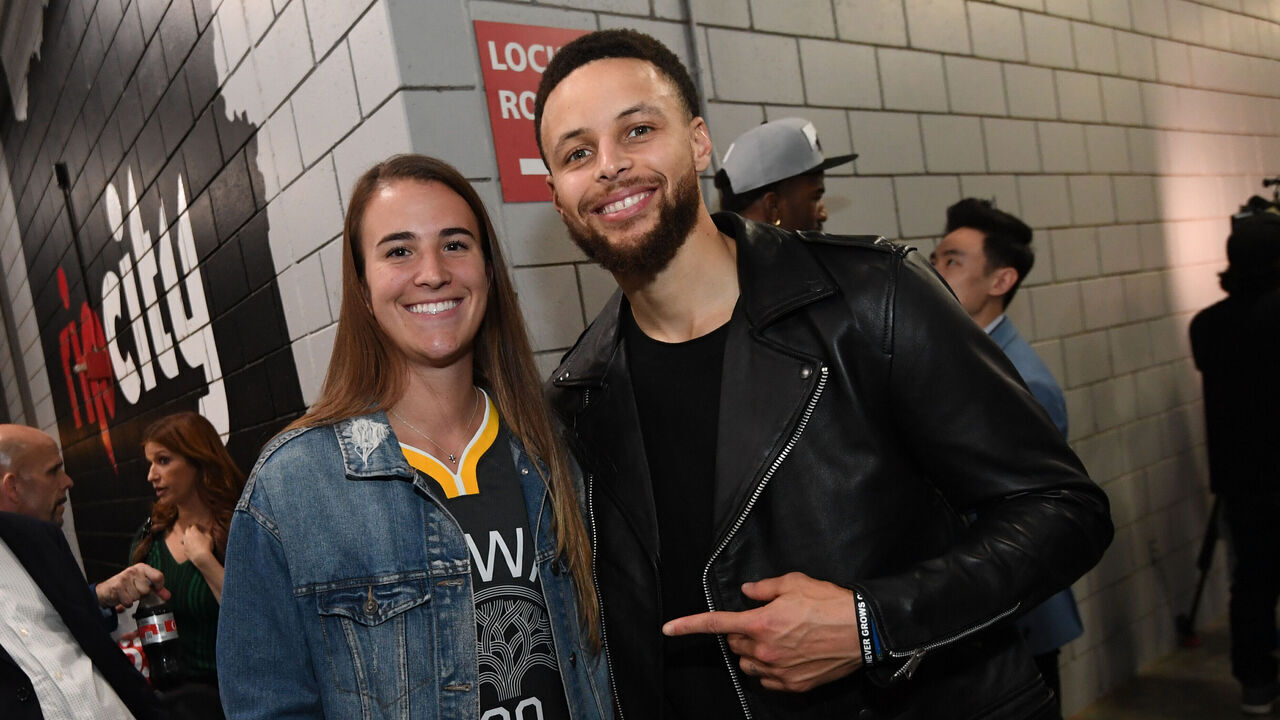 PORTLAND, OR - MAY 20: Stephen Curry #30 of the Golden State Warriors poses for a photo with Oregon Ducks Basketball player, Sabrina Ionescu, after advancing to the NBA Finals against the Portland Trail Blazers during Game Four of the Western Conference Finals on May 20, 2019 at the Moda Center in Portland, Oregon. NOTE TO USER: User expressly acknowledges and agrees that, by downloading and/or using this photograph, user is consenting to the terms and conditions of the Getty Images License Agreement. Mandatory Copyright Notice: Copyright 2019 NBAE