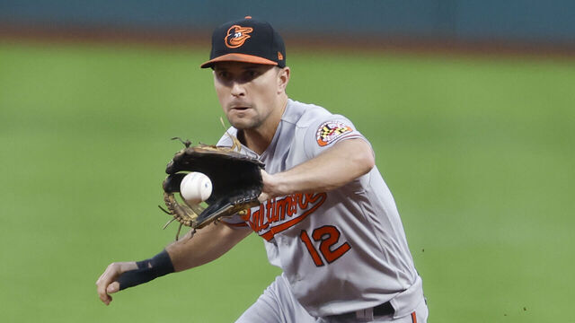 CLEVELAND, OH - SEPTEMBER 21: Adam Frazier #12 of the Baltimore Orioles fields the ball and throws out Steven Kwan #38 of the Cleveland Guardians at first base during the first inning at Progressive Field on September 21, 2023 in Cleveland, Ohio.