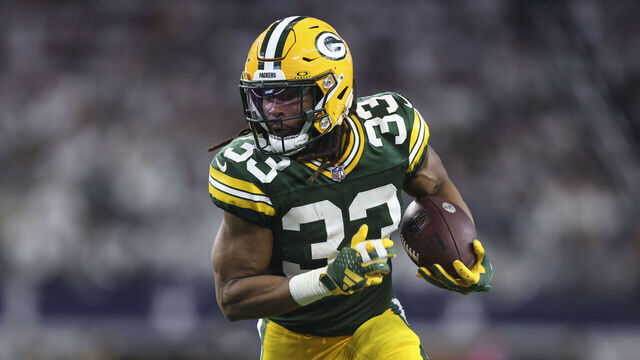 ARLINGTON, TX - JANUARY 14: Aaron Jones #33 of the Green Bay Packers runs the ball during an NFL wild-card playoff football game against the Dallas Cowboys at AT&T Stadium on January 14, 2024 in Arlington, Texas.