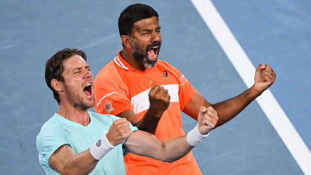 India's Rohan Bopanna (R) and Australia's Matthew Ebden celebrate after victory against Italy's Simone Bolelli and Andrea Vavassori during their men's doubles final match on day 14 of the Australian Open tennis tournament in Melbourne on January 27, 2024.
