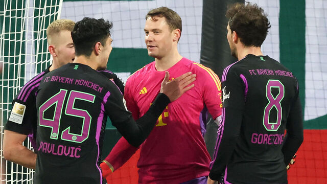 AUGSBURG, GERMANY - JANUARY 27: Manuel Neuer of Bayern Muenchen celebrates after the penalty with Aleksandar Pavlovic of Bayern Muenchen and Matthijs de Ligt of FC Bayern Muenchen during the Bundesliga match between FC Augsburg and FC Bayern München at WWK-Arena on January 27, 2024 in Augsburg, Germany.
